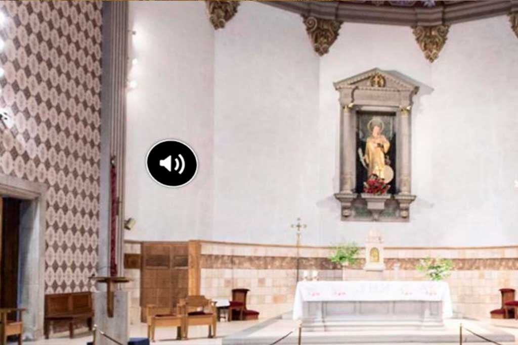 Simbol d'audioguia a l'església de Sant Vicenç de Tossa de Mar (La Selva)